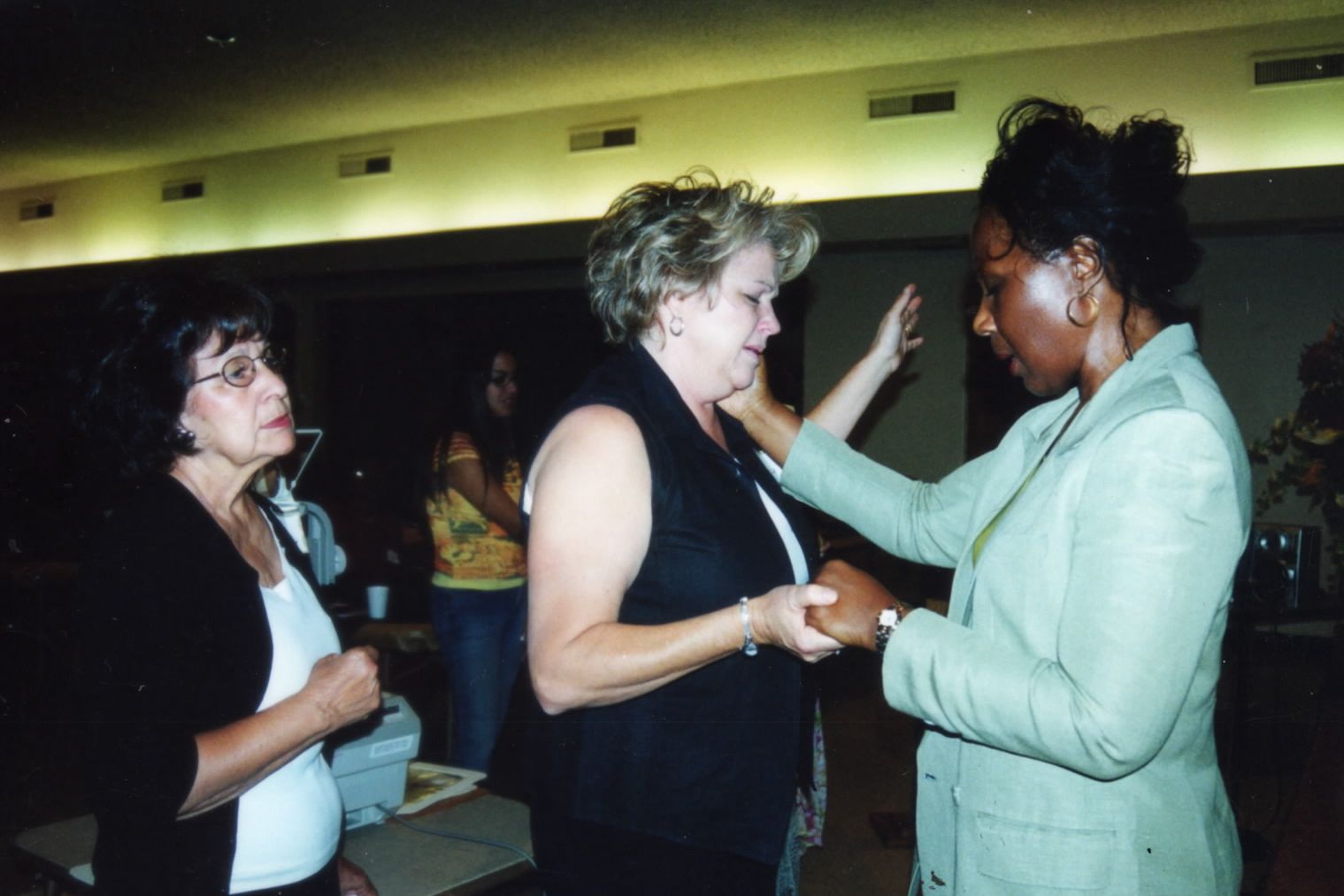 A woman receiving prayer at a gathering